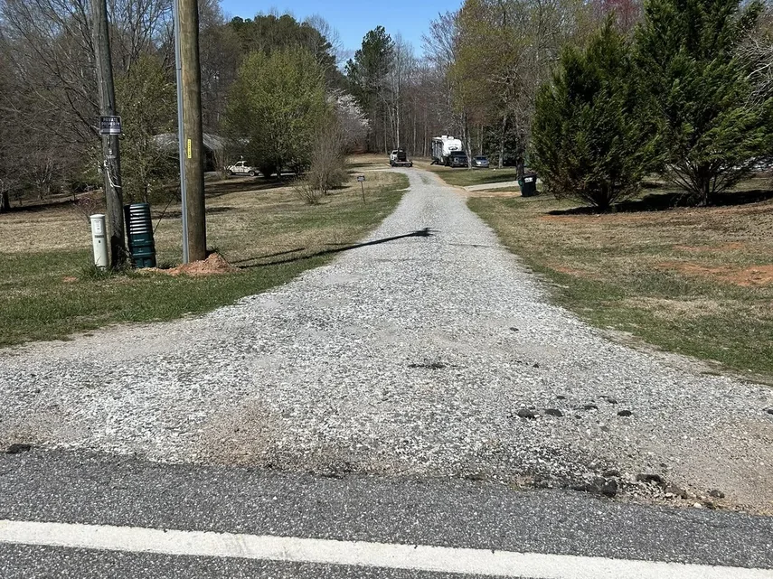 Reconditioned gravel drive leading in from the road, gravel driveway repair